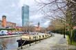 The Bridgewater canal at Manchester with a longboat tied up on the quay.
