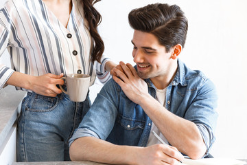 Wall Mural - Attractive young couple drinking coffee