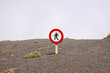 © Ralf - Mirador del Rio - Lanzarote: Isolated round sign do not walk here above clouds on dry stony ground at steep mountain side