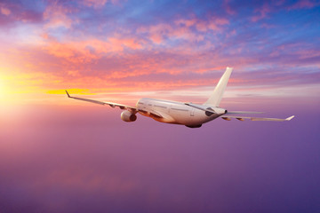 Passengers commercial airplane flying above clouds