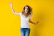 © Krakenimages.com - Beautiful young blonde woman jumping happy and excited over isolated yellow background