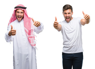 Collage of handsome young man and arab man over isolated background approving doing positive gesture with hand, thumbs up smiling and happy for success. Looking at the camera, winner gesture.