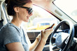 © Cavan Images - Woman using smart phone in car during summer