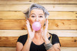 © simona - Funny and alternative old people caucasian beautiful woman with pink bubble chewing gum - portrait of youth active senior lady having fun - no limit age lifestyle concept