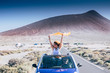 © simona - Freedom and travel concept for independent adult caucasian women together with convertible car - people traveling and enjoying tie friendship - drive and road concept