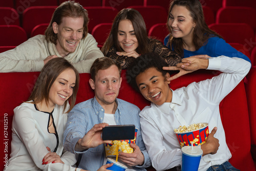 Funny Company Watching Comedy In Cinema And Taking Selfie On Phone