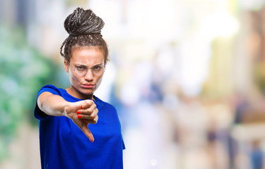 Wall Mural - Young braided hair african american girl wearing glasses over isolated background looking unhappy and angry showing rejection and negative with thumbs down gesture. Bad expression.