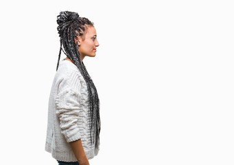 Wall Mural - Young braided hair african american girl wearing sweater over isolated background looking to side, relax profile pose with natural face with confident smile.