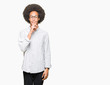 © Krakenimages.com - Young african american man with afro hair wearing glasses asking to be quiet with finger on lips. Silence and secret concept.