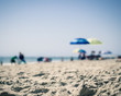 © Molly Southern - Blurred Out People and Umbrellas on a Beach, Sand in Focus