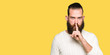 © Krakenimages.com - Young hipster man wearing winter sweater asking to be quiet with finger on lips. Silence and secret concept.