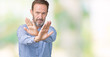 © Krakenimages.com - Handsome middle age elegant senior man over isolated background Rejection expression crossing arms and palms doing negative sign, angry face