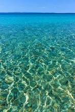 Close-up Photo Of Clear, Shallow Sea Water In Sithonia, Greece. Summer Scenery
