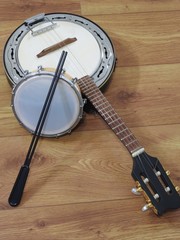 Wall Mural - Two Brazilian musical instruments: samba banjo and tamborim with drumstick on a wooden surface. They are widely used to accompany samba, the most popular Brazilian rhythm.