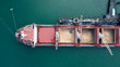 © ManHin - Top down aerial view of Container ship unloading sugar shipment at cargo depot 4k