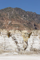 view of the Caldera of the volcano on Nisyros, a huge crater with snow-white sediments, sulfur crystals, from a height, the landscape around resembles a desert