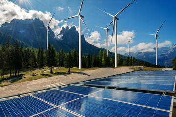 Wall Mural - Solar energy panel photovoltaic cell and wind turbine farm power generator in nature landscape for production of renewable green energy is friendly industry. Clean sustainable development concept.