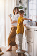 © Alena Ozerova - Pregnant mom with kid cooking together in the kitchen