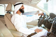 © master1305 - Successful arab saudi businessman riding his car or driving full of emotions at sunny day. Male model as an enterpreneur. Concept of business, finance, modern technologies, start up, economy.