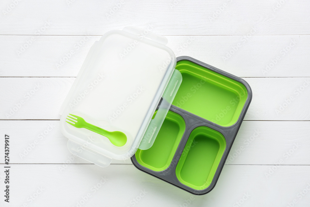 Plastic lunch box on white wooden background