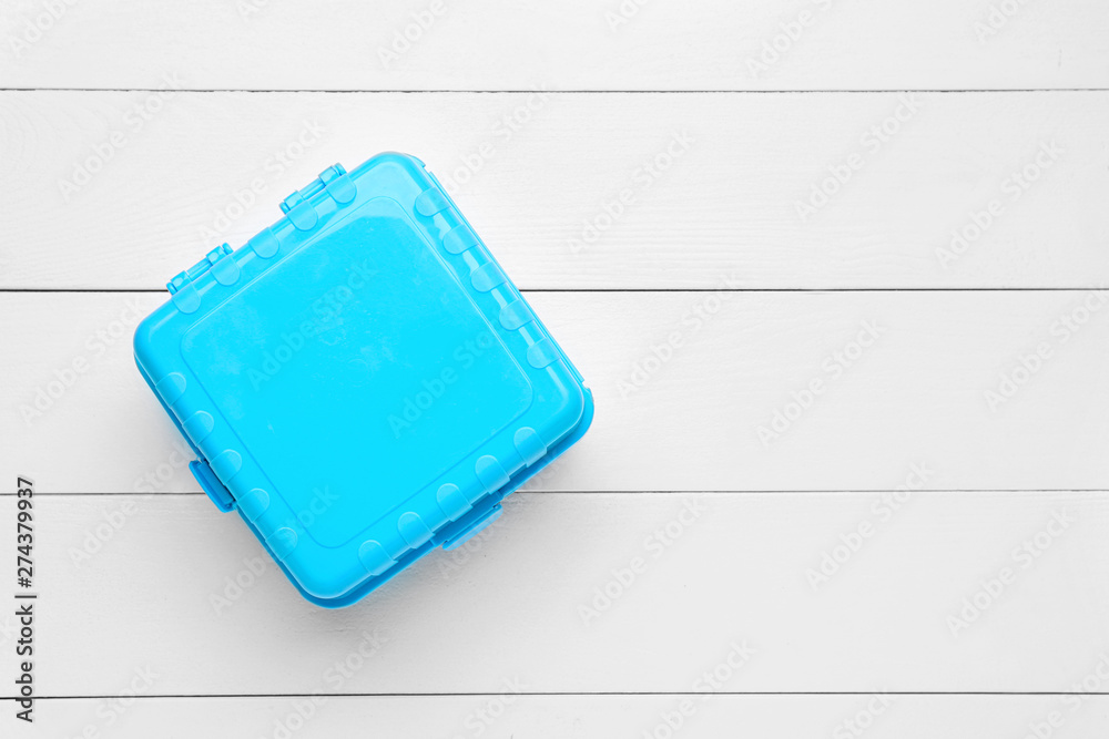 Plastic lunch box on white wooden background