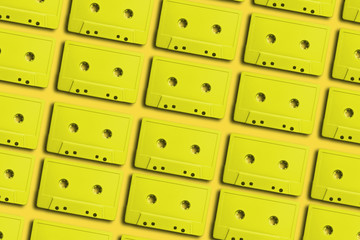 Poster - Beautiful Yellow magnetic cassette tapes flat background. Creative Concept Of Retro Style.