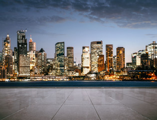 Wall Mural - empty road, sidewalk with the the city at night in the background with copy space