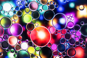 bright oil bubbles in water with abstract pattern