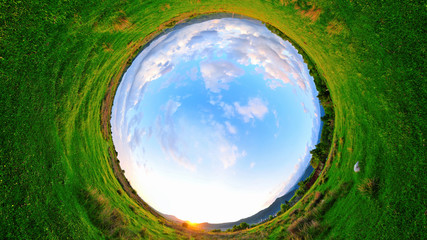 stereographic panoramic projection of a green field in the summer. 360 degree panorama.