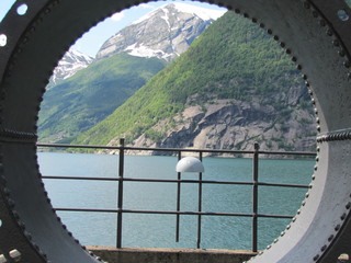 Mountains and Fjord through Old Pipe in Norway