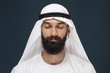 © master1305 - Half-length portrait of arabian saudi businessman on dark blue studio background. Young male model with closed eyes thinking. Concept of business, finance, facial expression, human emotions.
