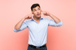 © luismolinero - Handsome man over pink background having doubts and thinking