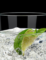 Poster - Gin tonic, soda or vodka with lime in glass isolated on black background