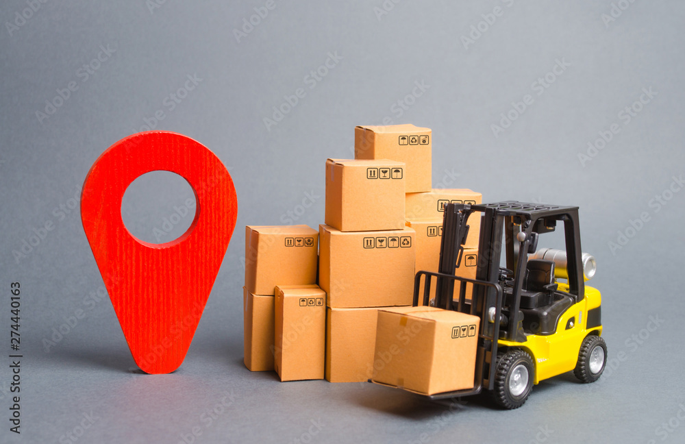 Yellow Forklift truck with cardboard boxes and a red position pin ...