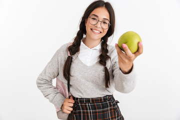 Sticker - Photo closeup of caucasian teenage girl wearing eyeglasses and backpack eating green apple