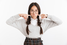 Photo Closeup Of Funny Teenage Girl Wearing Eyeglasses Touching Her Cheeks While Holding Breath