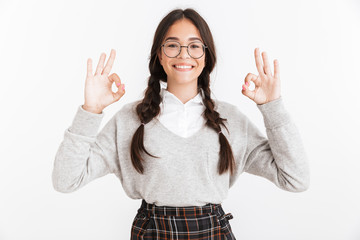 Canvas Print - Photo closeup of beautiful teenage girl wearing eyeglasses and school uniform smiling while showing ok sign with fingers