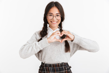 Wall Mural - Photo closeup of caucasian teenage girl wearing eyeglasses and school uniform smiling while showing heart shape with fingers