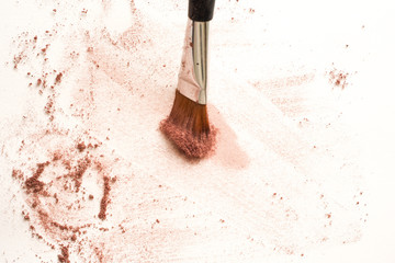 Wall Mural - Make up brush on white surface, cosmetic makeup powder exploding as it impacts table