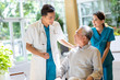 © Blue Jean Images - Young doctor talking with patient in nursing home