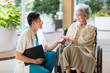 © Blue Jean Images - Young doctor talking with patient in nursing home