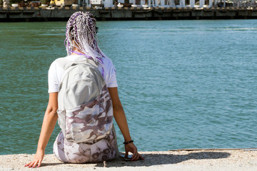 Wall Mural - young girl sitting on the dock