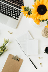 Wall Mural - Flatlay of modern workspace with laptop and sunflowers bouquet on white background. Top view summer floral blogger composition.