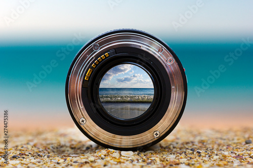 Fotomural View of the sea surf through a photographic lens lying on a sandy beach on a sunny day