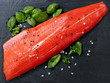 © tab62 - Fresh raw pacific wild sockeye salmon fillet on natural stone with spices and basil leaves