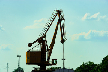 Port crane for unloading coal for an electric thermal station. against the blue sky