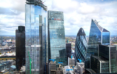 Sticker - City of London, UK. Skyline view of the famous financial bank district of London at golden sunset hour. View includes skyscrapers, office buildings and beautiful dramatic sky.