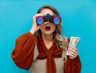 Wall Mural - Young woman with cash and binocular