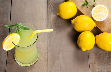 Wall Mural - Lemonade in glass.Homemade Refreshment Summer cold drink with fresh lemons and mint. Lemon mojito cocktail with juice