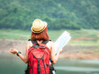 © Meawstory15Studio - Asia woman traveler hiking with backpack and camera at forest looking map the route go to destinations traveler doing vacation relax enjoying and hiking to mountain travel lifestyle,summer journey